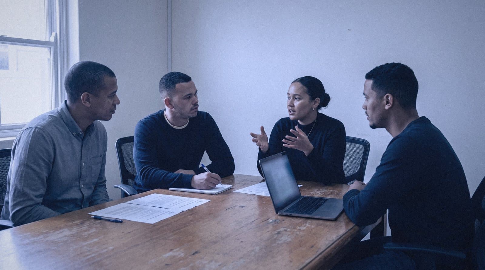 An owner and their team talking through how work moves through the business
